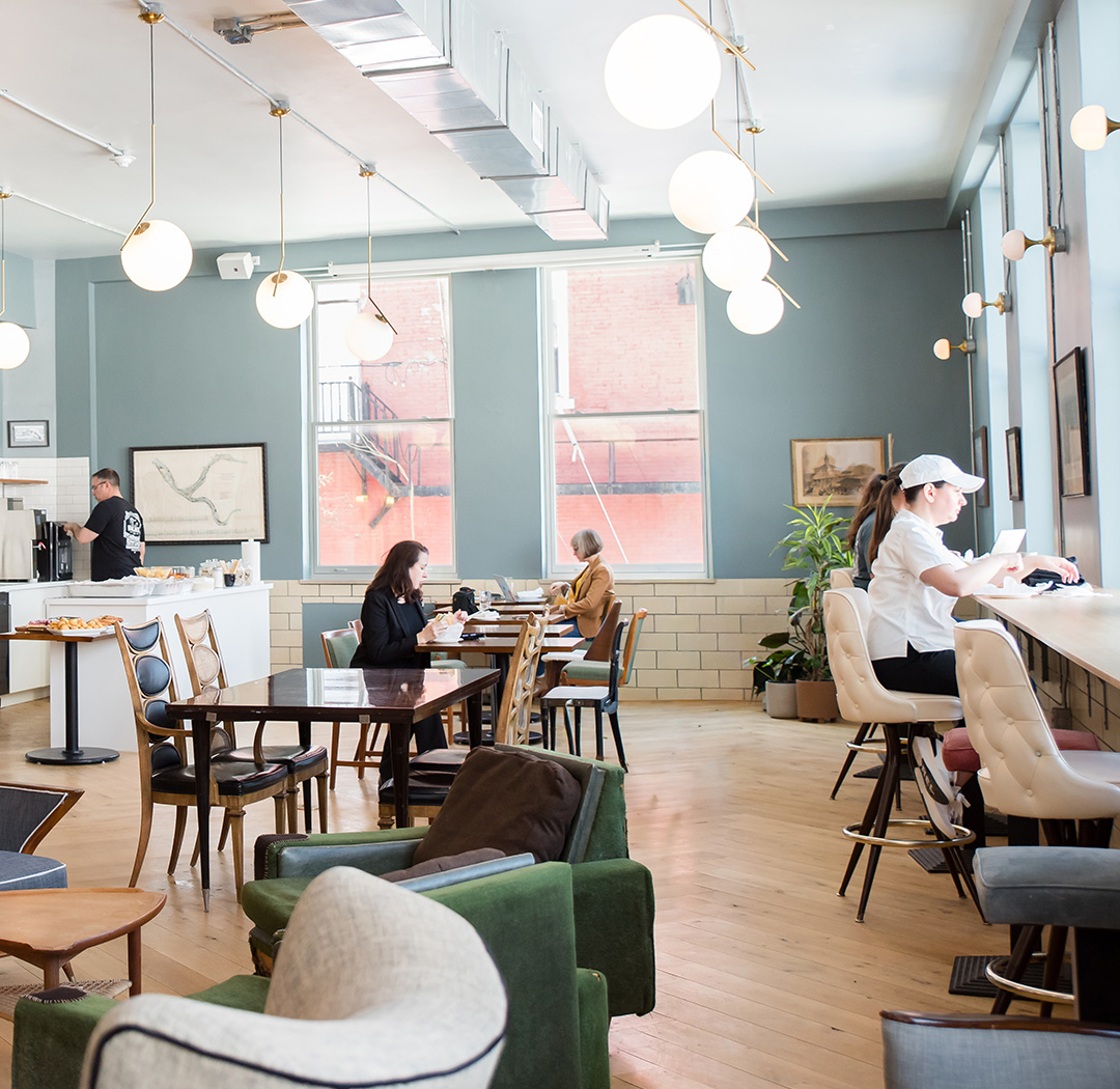 The Cafe at Fulton Commons coworking space Pittsburgh — open lounge with coffee bar, globe pendants, and natural light