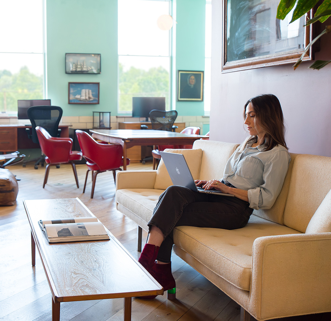 The Whimsical Film Set Room at Fulton Commons coworking space Pittsburgh — lounge seating with sofas and large windows