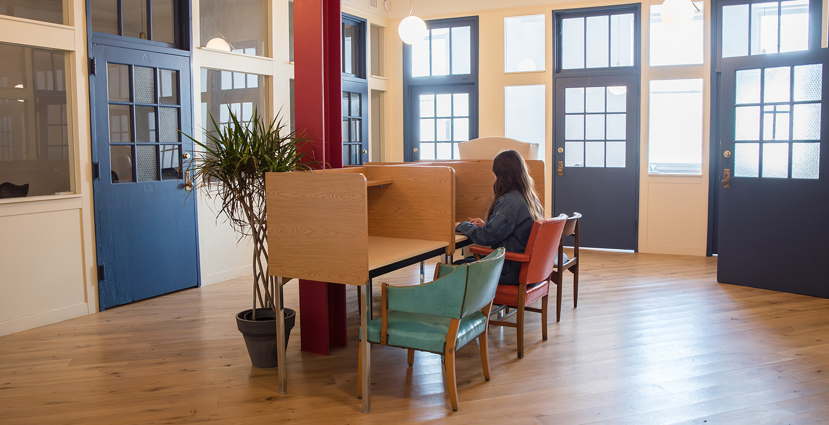 The Schoolhouse Room at Fulton Commons coworking space Pittsburgh — focus desks and study booths with tall windows