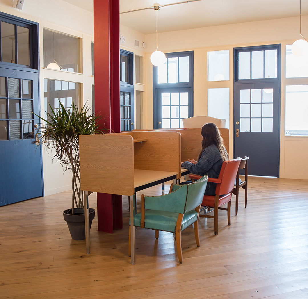 The Schoolhouse Room at Fulton Commons coworking space Pittsburgh — focus desks and study booths with tall windows