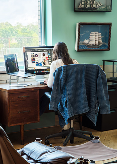 Dedicated desk coworking at Fulton Commons Pittsburgh — private desk with monitor by a window