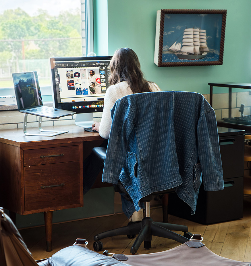 Dedicated desk coworking at Fulton Commons Pittsburgh — private desk with monitor by a window