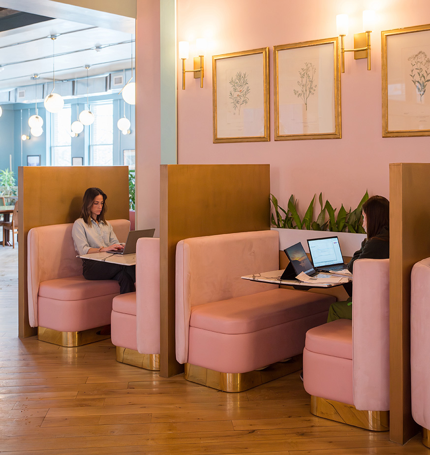 Open seating coworking membership at Fulton Commons Pittsburgh — pink lounge booths with natural light