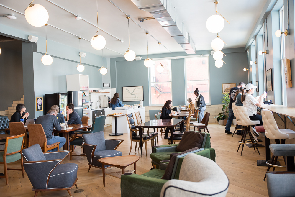 Cafe entrance area with open coworking seating at Fulton Commons Pittsburgh