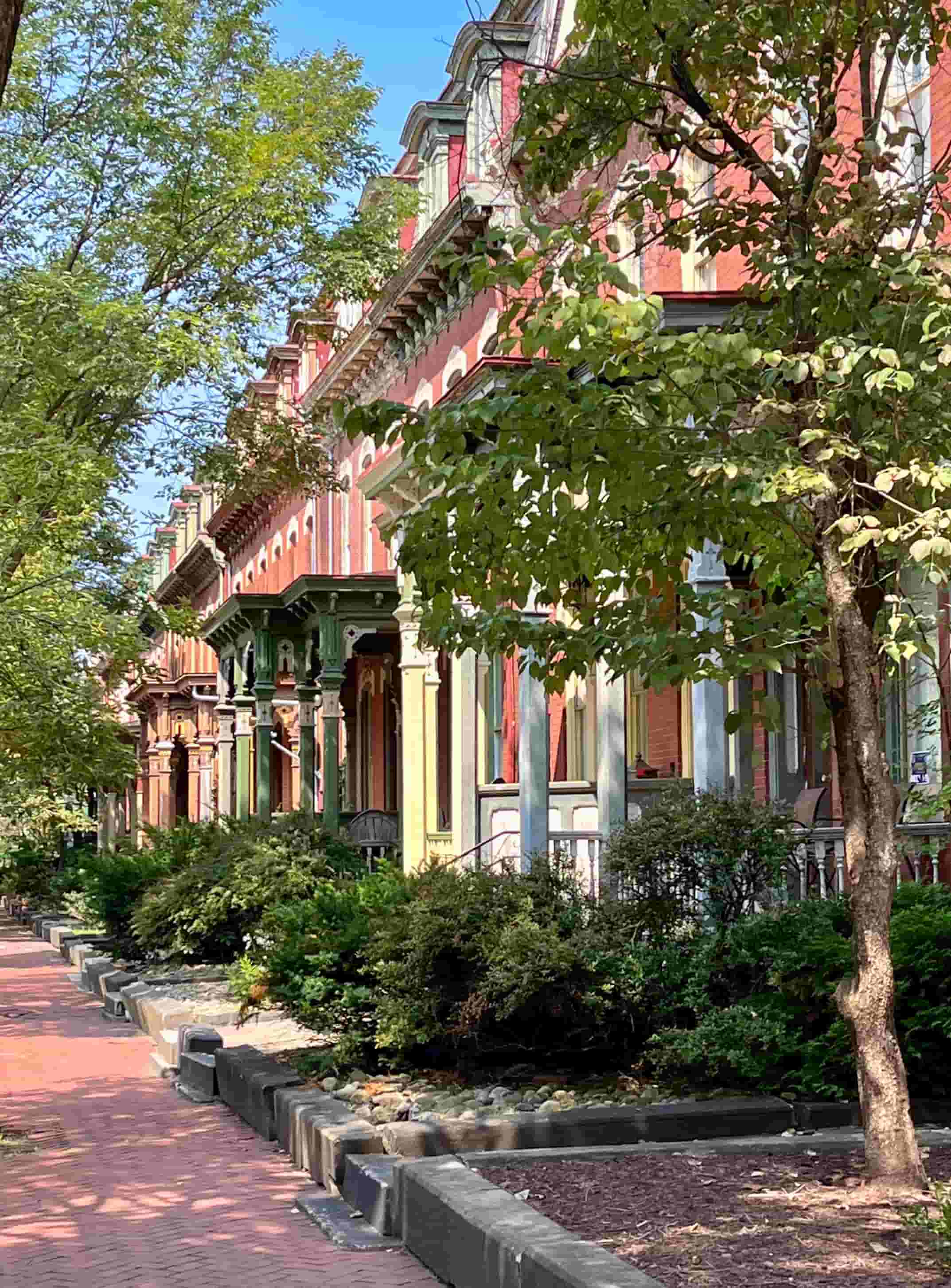 Historic Victorian rowhouses on a tree-lined street in Manchester, Pittsburgh