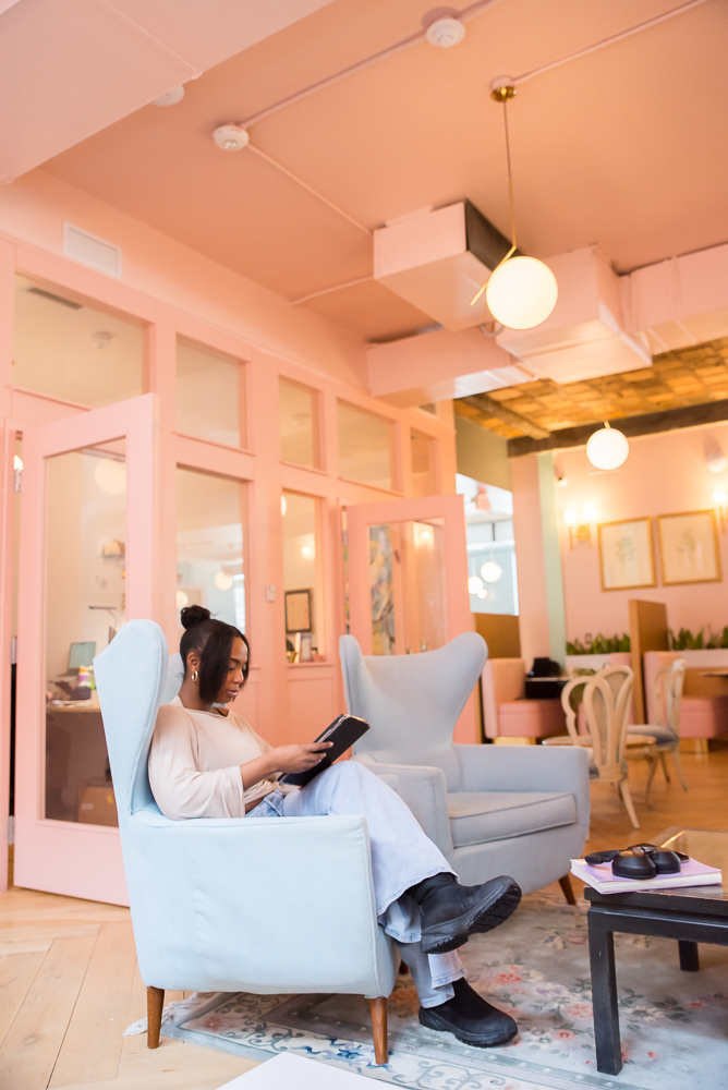 Member reading in a lounge area at Fulton Commons Pittsburgh